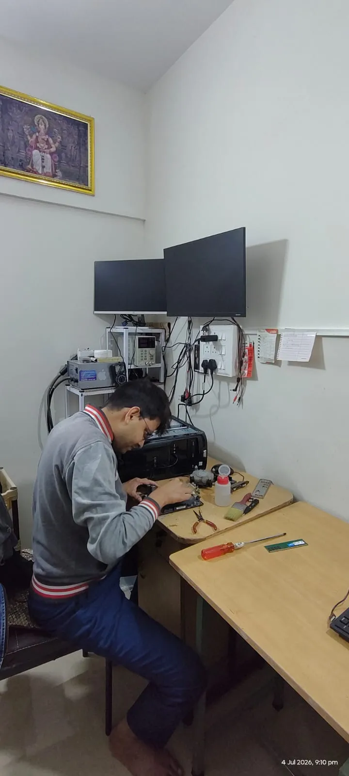 LapDesk technician performing precision hardware repair under work light